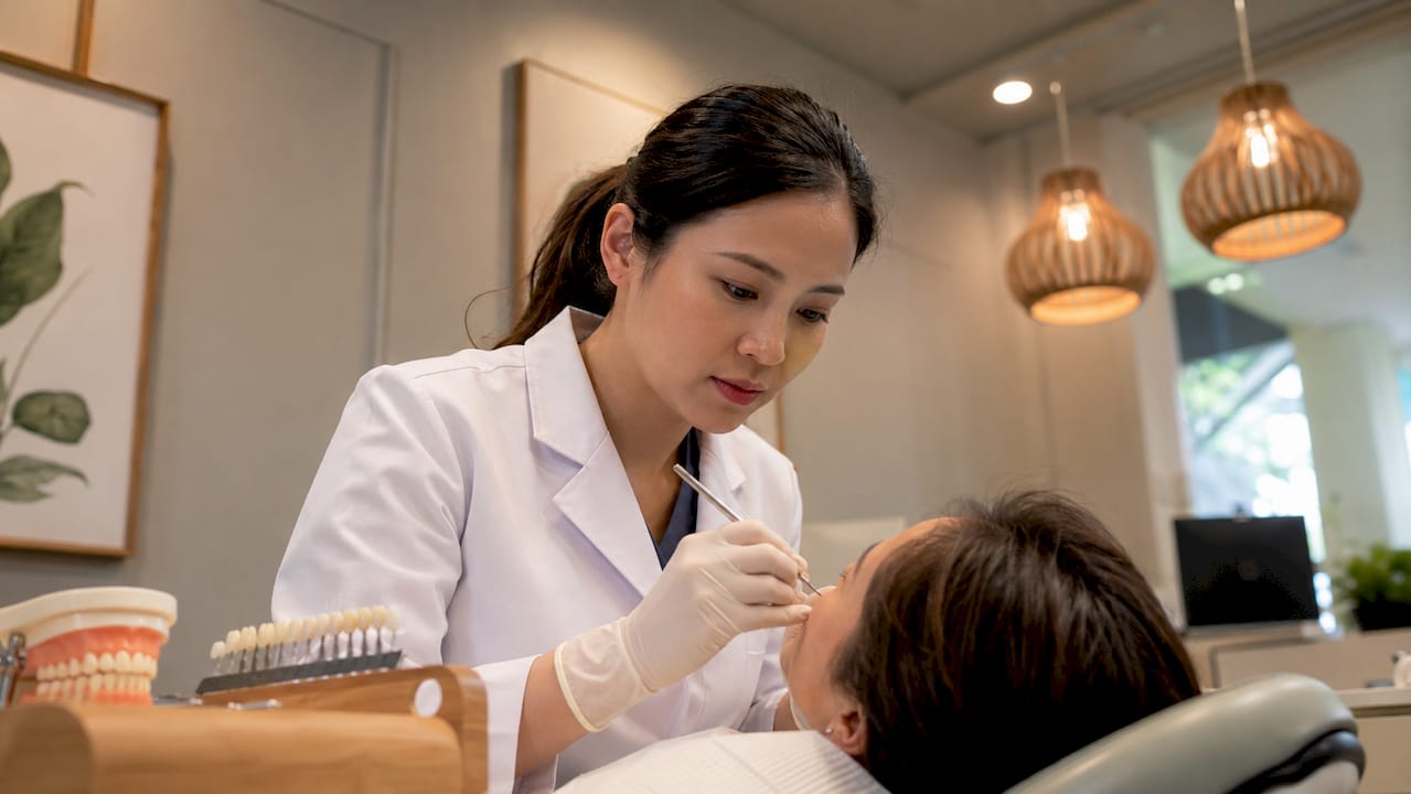 Dentist performing composite bonding on front tooth