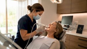 Dentist scanning patient's teeth with intraoral scanner